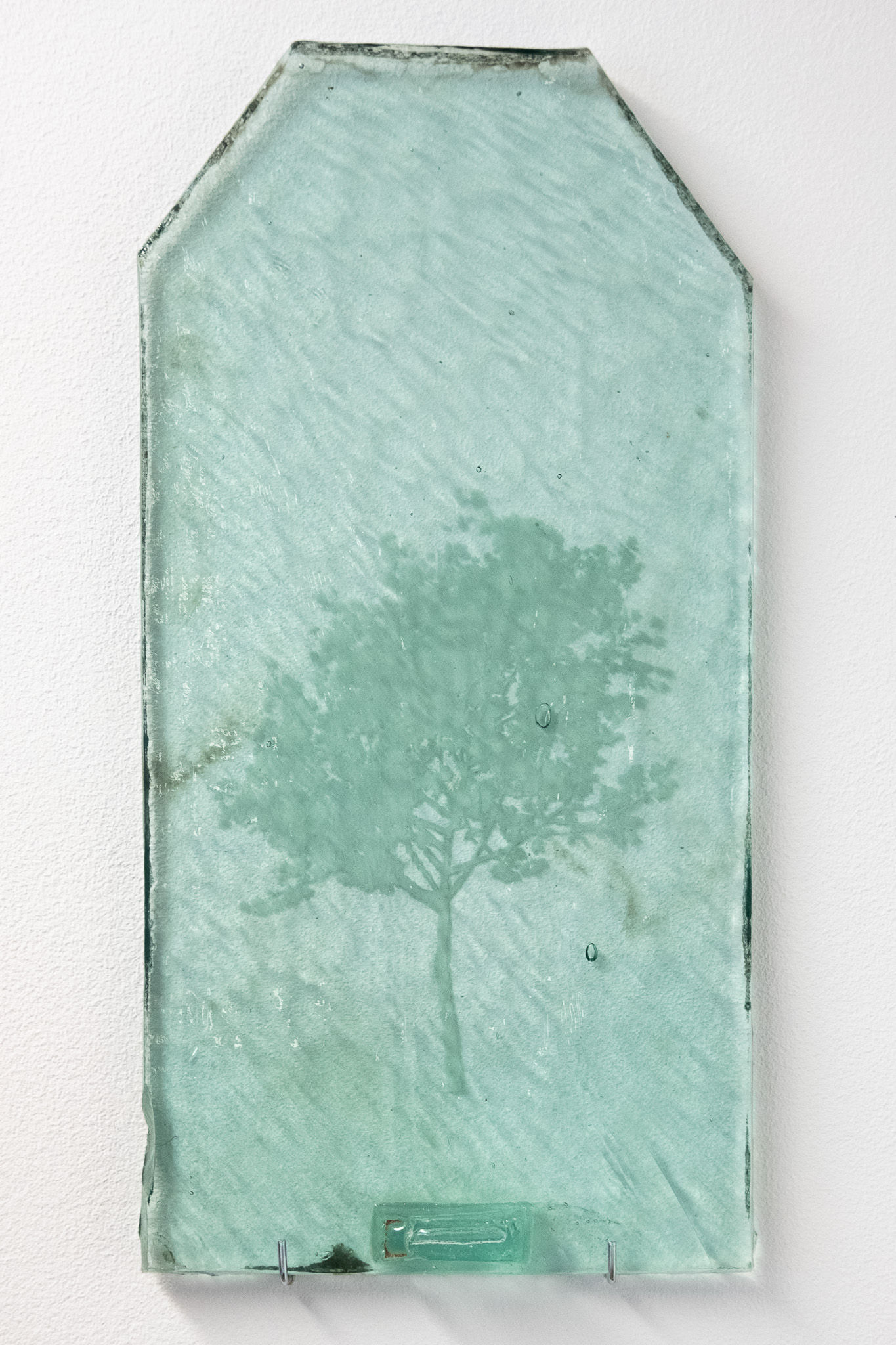 Close-up of an engraved glass tile showing the texture.