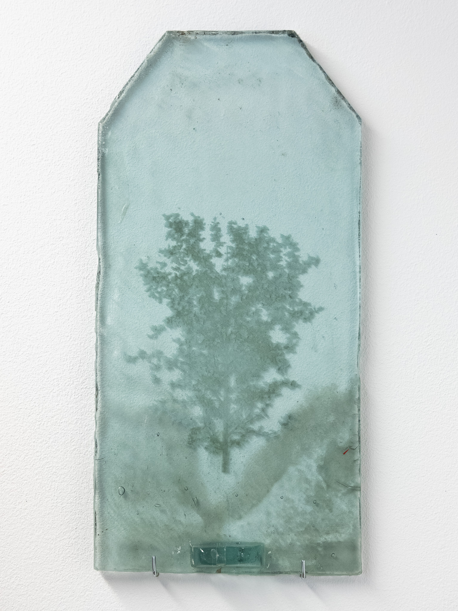 Several engraved glass tiles stacked together.